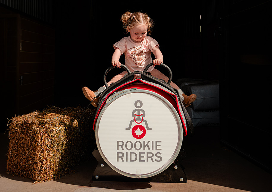 Young child developing balance and confidence on a barrel horse in Foxwood's Rookie Riders program