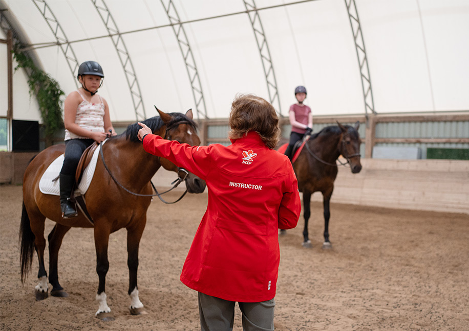 Rider practicing horsemanship skills during Ontario Equestrian Rider Level lesson at Foxwood